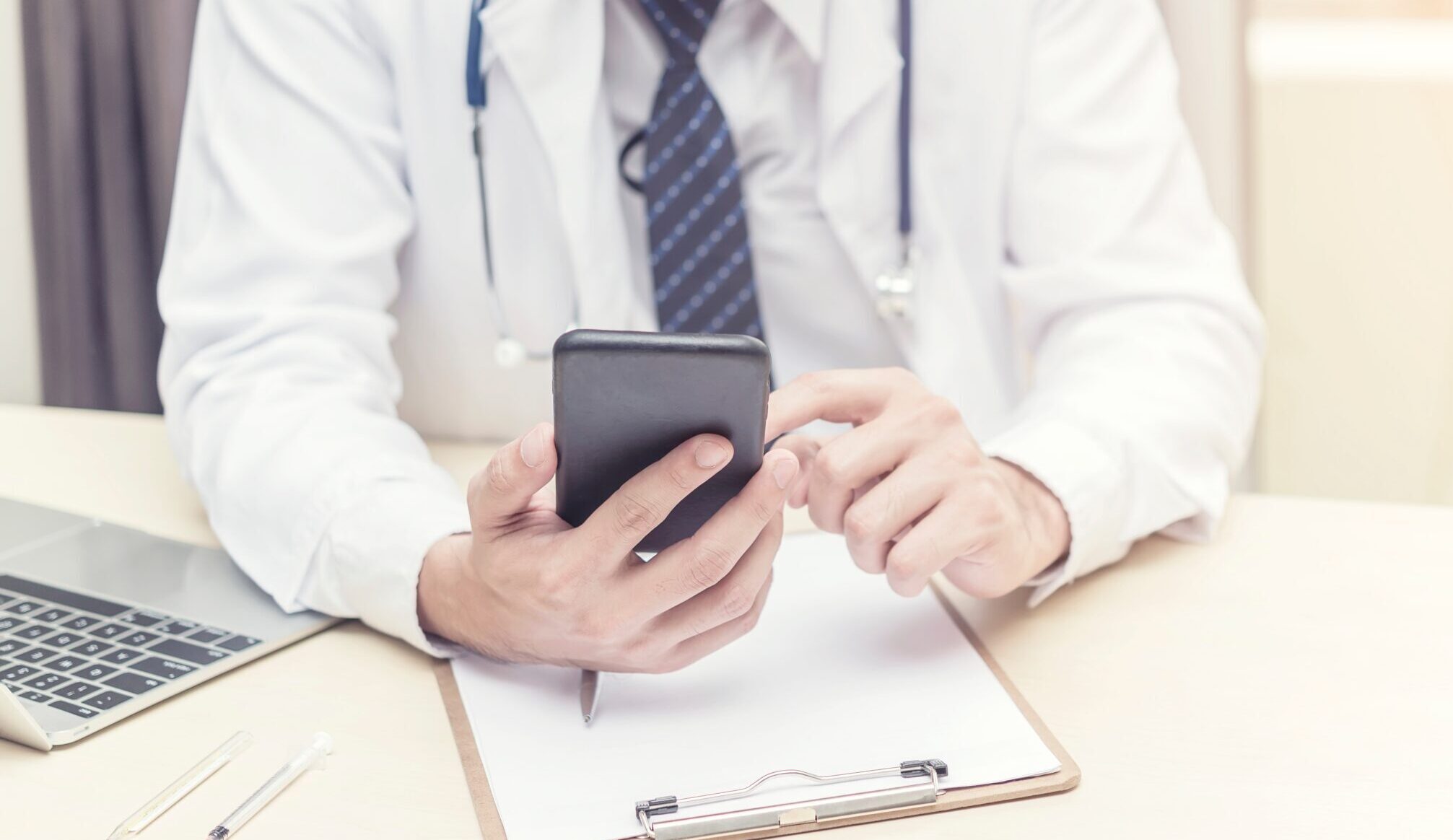 Doctor working and searching information on mobile at office. Treatment and technology concept. Picture for add text message. Backdrop for design art work.